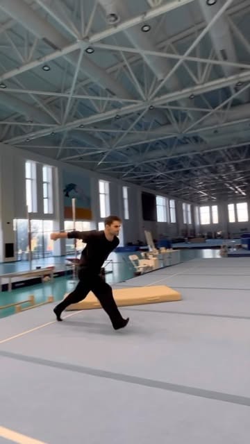 Orkhan sprinting into a tumbling pass in a gymnastics hall